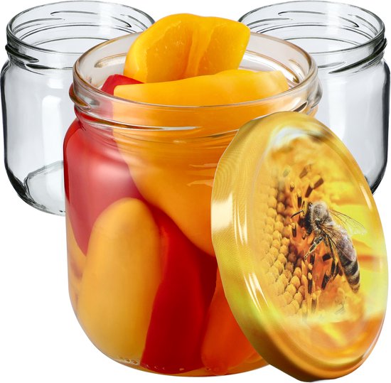 Bocal en verre rempli de poivrons rouges et jaunes, avec un couvercle à motif d'abeille.