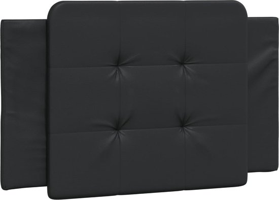 Détail d'une tête de lit noire capitonnée.