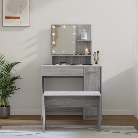 Coiffeuse grise avec miroir, éclairage et tabouret, installée dans une chambre.