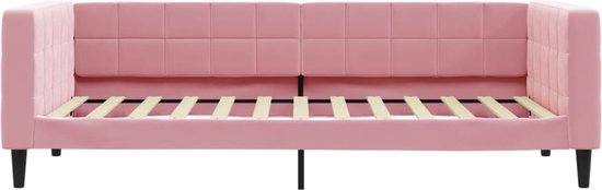 Frontaal zicht op een lichtroze slaapbank met gecapitonneerd zitvlak en rugleuning, met uitgeschoven bedframe.