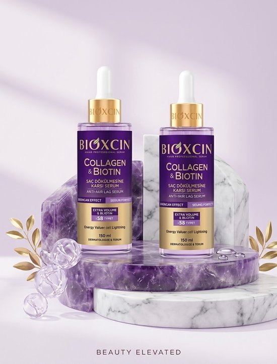 Twee flessen Bioxcin Collagen & Biotin haarserum in paarse verpakking met gouden letters, op een marmeren sokkel.