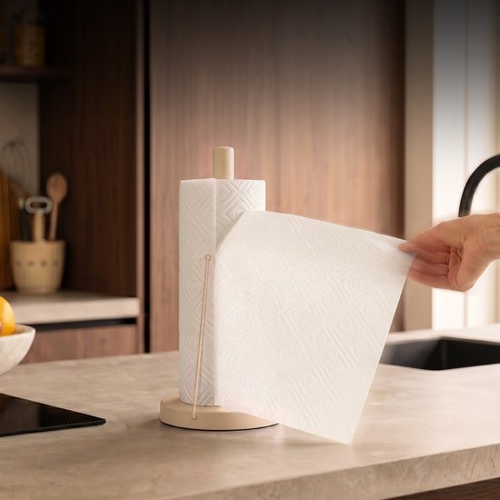 Hand trekt een vel keukenpapier van een beige keukenrolhouder met anti-rol arm.