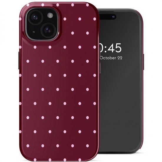 Coque de téléphone bordeaux à pois roses à côté d'un iPhone 15.