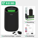 Zwarte Strex luchtontvochtiger met adapter en handleiding in de doos.