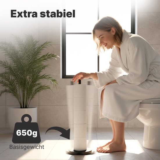 Vrijstaande zwarte toiletrolhouder voor 5 rollen, met een vrouw in een witte badjas die ernaast zit. Tekst: Extra stabiel, 650g Basisgewicht.