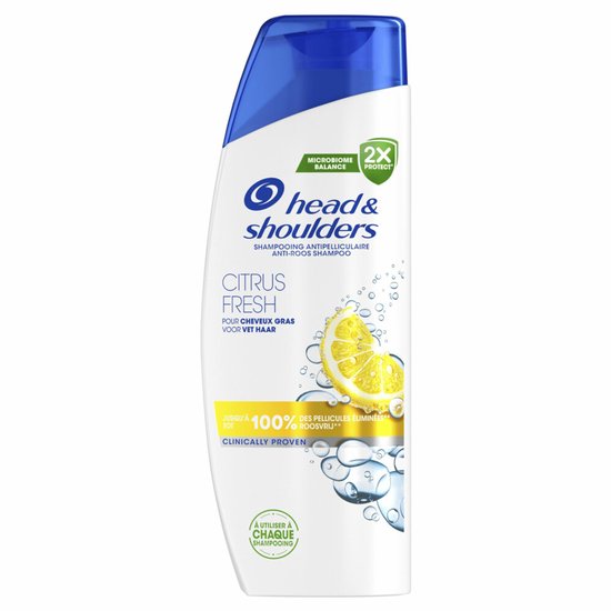 Bouteille de shampooing Head & Shoulders Citron Frais avec bouchon bleu et un demi-citron.