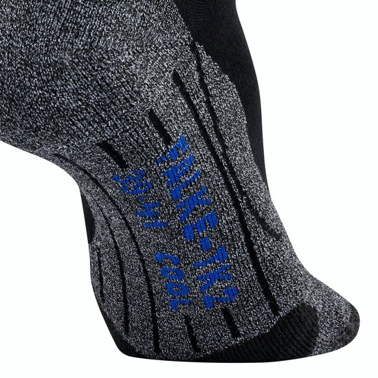 Dichtbij opname van een zwarte FALKE sok met grijze accenten en blauwe tekst.