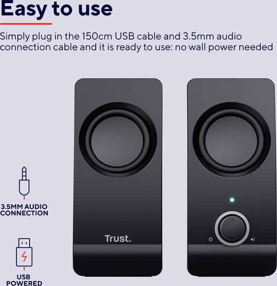 Twee zwarte Trust speakers met ronde speakers, volumeknop en indicatielampje. USB-gevoed, 3.5mm audio-aansluiting.