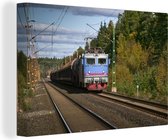 Un train sur un chemin de fer Toile 60x40 cm - Tirage photo sur toile (Décoration murale salon / chambre)
