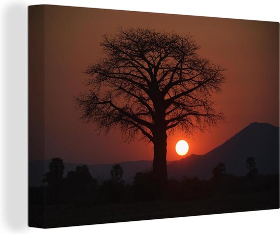 Canvas schilderij 180x120 cm - Wanddecoratie Zonsondergang achter een boom in het Nationaal park Lower Zambezi - Muurdecoratie woonkamer - Slaapkamer decoratie - Kamer accessoires - Schilderijen