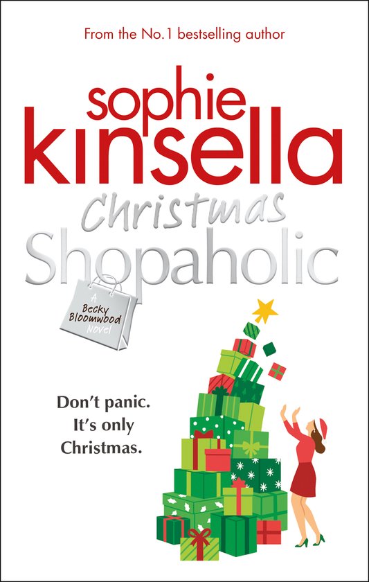 Boekomslag: "Christmas Shopaholic" door Sophie Kinsella. Een vrouw in kerstkleding klimt op een stapel kerstcadeaus. "Don't panic. It's only Christmas."