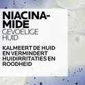 Tekst "NIACINAMIDE GEVOELIGE HUID, KALMEERT DE HUID EN VERMINDERT HUIDIRRITATIES EN ROODHEID" op lichte achtergrond met waterdruppels.