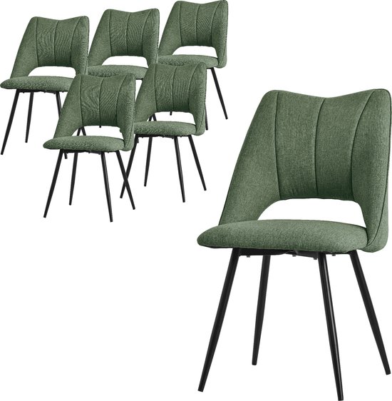 Chaise de salle à manger verte avec pieds noirs, avec cinq chaises en arrière-plan.