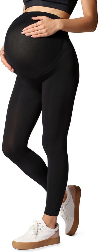 Zwangere vrouw in een zwarte legging en sportbeha, detail van haar buik en benen.
