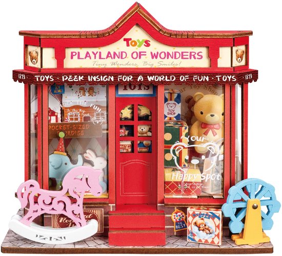 Miniatuur speelgoedwinkel 'Playland of Wonders' met roze wip, blauwe olifant, konijn, teddybeer en reuzenrad.