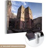 MuchoWow® Glasschilderij 120x80 cm - Schilderij acrylglas - Lalibela de rots gehouwen kerk in zonlicht Ethiopië - Foto op glas - Schilderijen