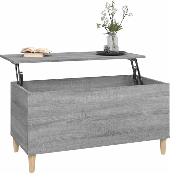 Grijze salontafel met houtnerf, opklapbaar blad, op houten pootjes, met decoratie.