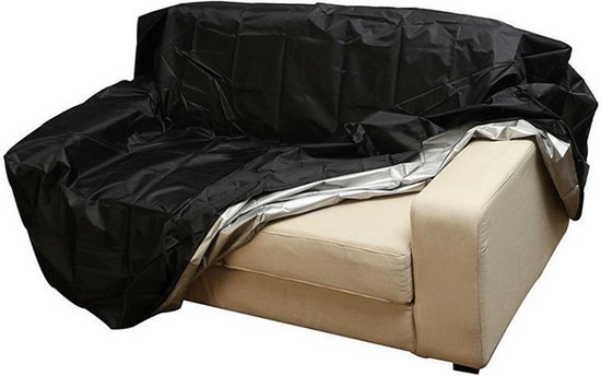 Housse de protection noire à moitié sur un canapé en tissu beige, intérieur argenté visible.
