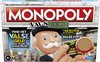 Monopoly Valse Geld speldoos met Mr. Monopoly die een detector vasthoudt. Tekst: "Vind het valse geld en word schatrijk!"
