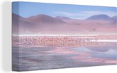 Canvas schilderij 160x80 cm - Wanddecoratie Een grote groep flamingo's in een roze en blauw landschap - Muurdecoratie woonkamer - Slaapkamer decoratie - Kamer accessoires - Schilderijen