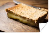 Tosti met gesmolten kaas op een snijplank poster 120x80 cm - Foto print op Poster (wanddecoratie woonkamer / slaapkamer)