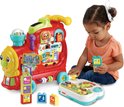 Rode VTech trein met kleuter die ermee speelt, interactieve knoppen, blokken en dieren.
