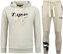 Beige trainingspak met hoodie en joggingbroek. Hoodie met tekst "Tupac love of the land". Joggingbroek met grafische print van Tupac op de broekspijp.