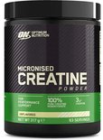 Zwarte pot met groene en witte letters. Micronised Creatine Powder. Netto 317g.