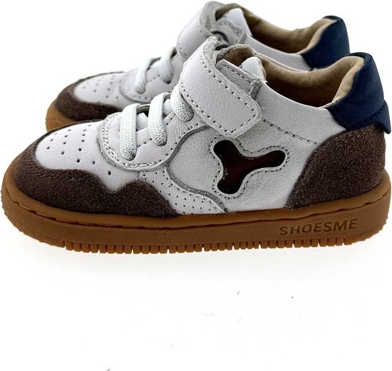Paar witte leren sneakers met bruine suède details, klittenband en 'SHOESME' op de zool.
