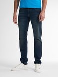 Voorkant van een man in blauw t-shirt en spijkerbroek, staand.