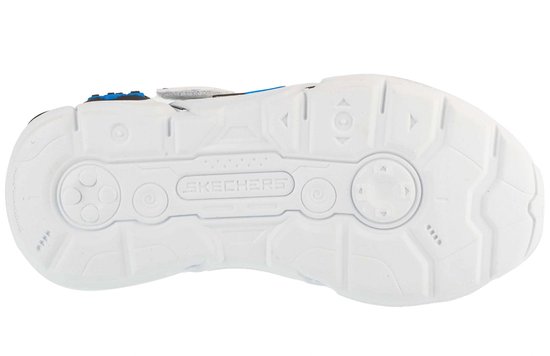 Onderkant van een witte sneaker met een "Skechers" logo in het midden en cirkelvormige patronen.