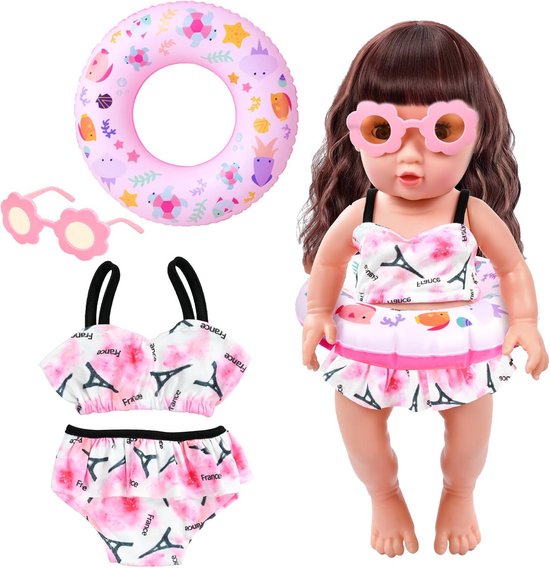 Pop met lange bruine haren, draagt roze bikini met Eiffeltoren print, roze bloemvormige zonnebril, met zwempak en zwemband ernaast.