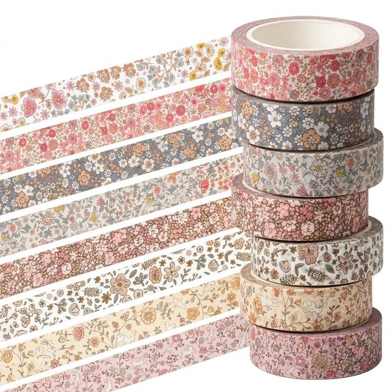 Pile de rouleaux de ruban washi avec différents motifs floraux dans des tons roses, beiges et gris.