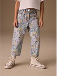 Model toont lichtblauwe, wijde jeans met all-over print van Smiley World-figuren, gedragen met witte sneakers.
