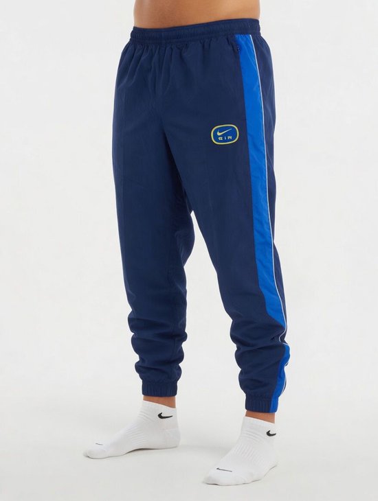 Navy Nike joggingbroek met gele en blauwe bies aan de zijkant en Nike Air logo.