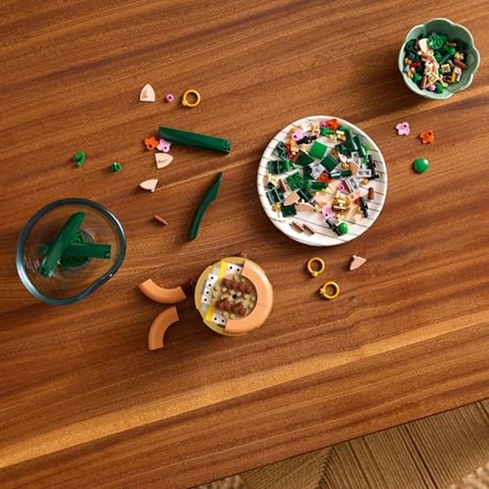 LEGO onderdelen voor de orchidee uitgestald op een houten tafel.