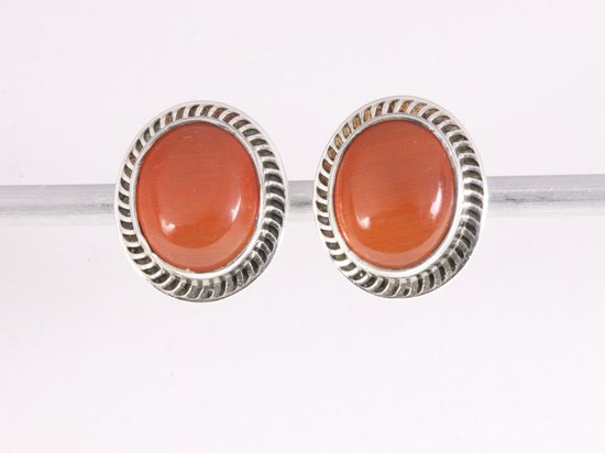 Bewerkte ovale zilveren oorstekers met rode vuuropaal