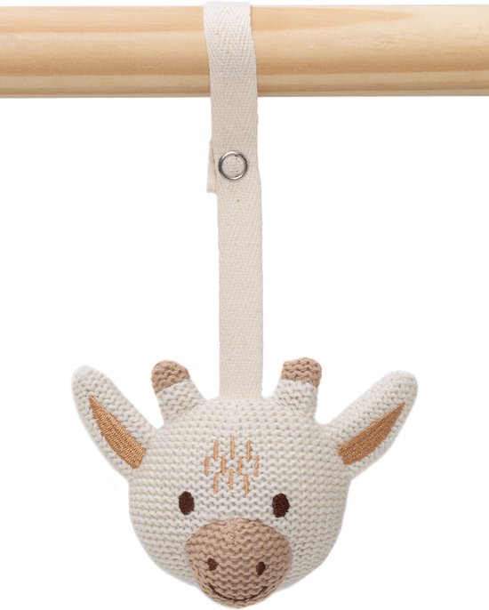 Witte gebreide giraffe knuffel met bruine accenten, hangend aan een houten stok.