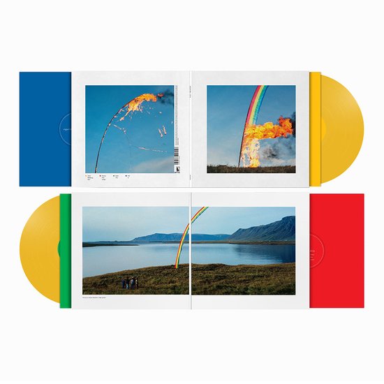 Gele dubbel LP met blauwe en rode hoes. De hoes toont een regenboog die in brand staat tegen een blauwe lucht, en een ander beeld van een regenboog met een landschap op de achtergrond.