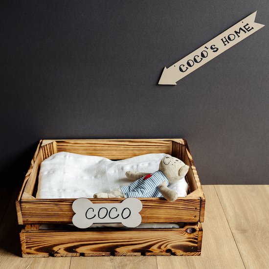 Houten pijl met tekst 'COCO'S HOME' hangt boven een houten kist met een teddybeer.