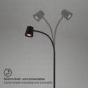 Zwarte staande lamp met draaibare en kantelbare lampenkap.