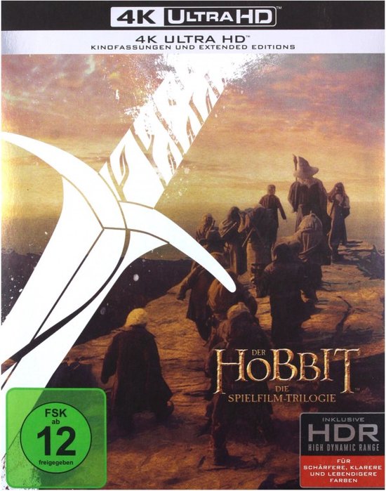 De voorkant van de 4K Ultra HD Blu-ray van de Hobbit trilogie toont een zwaard en een groep avonturiers op een rotsachtig pad.