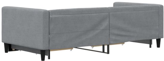 Grijze slaapbank, achterkant zichtbaar, met houten poten en stoffen bekleding.