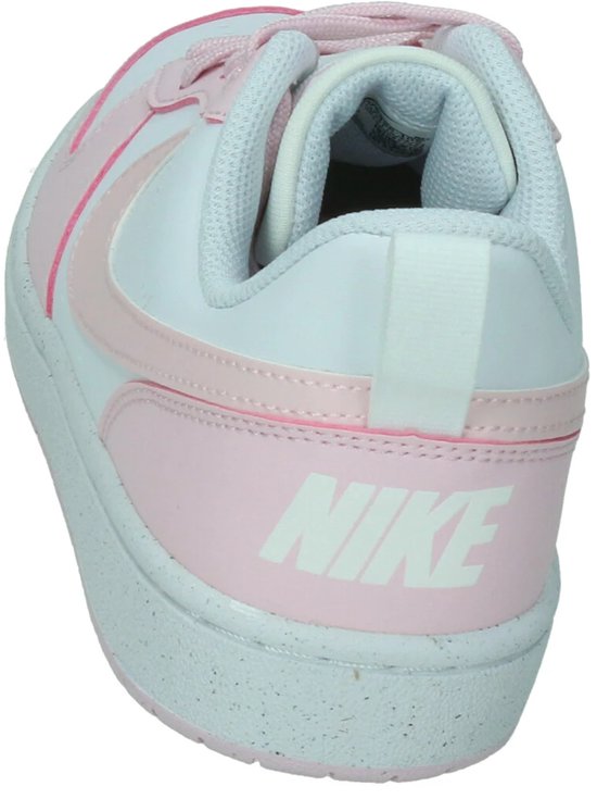 Nike Court Borough sneaker in wit en lichtroze met Nike-logo op de hiel en gespikkelde zool.