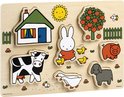 Houten puzzel met Nijntje, een koe, varken, schaap, ganzen, huisje en appelboom in felle primaire kleuren.