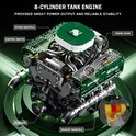 Gedetailleerd groen V8 tankmotor model met labels voor inlaatspruitstuk, schakelaar, timingketting, vliegwiel en uitlaatspruitstuk.