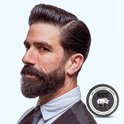 Zijaanzicht van een man met gestyled zwart haar en volle baard, naast een Reuzel Extreme Hold Matte Pomade blik.