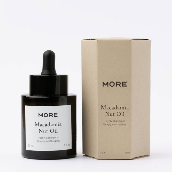 Zwarte fles macadamia olie van MORE, naast een kartonnen doos.
