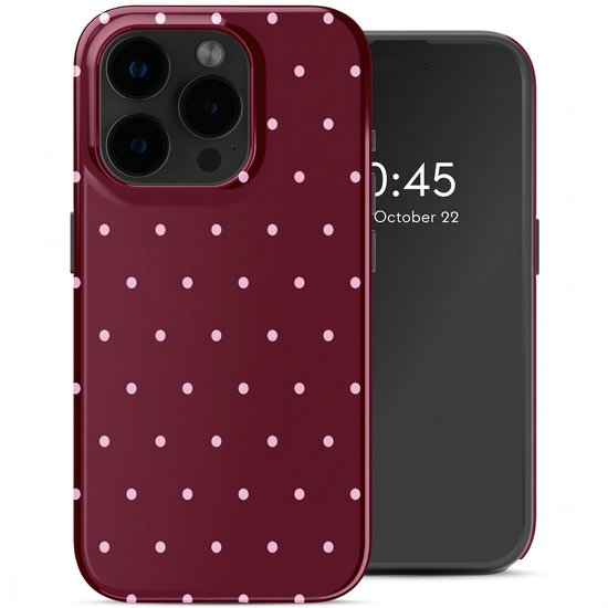 Coque de téléphone bordeaux à pois blancs, à côté d'un smartphone.