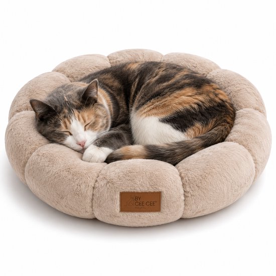Un chat écaille de tortue dort dans un panier rond et doux pour chat, couleur moka, avec un bord surélevé et une étiquette marron.